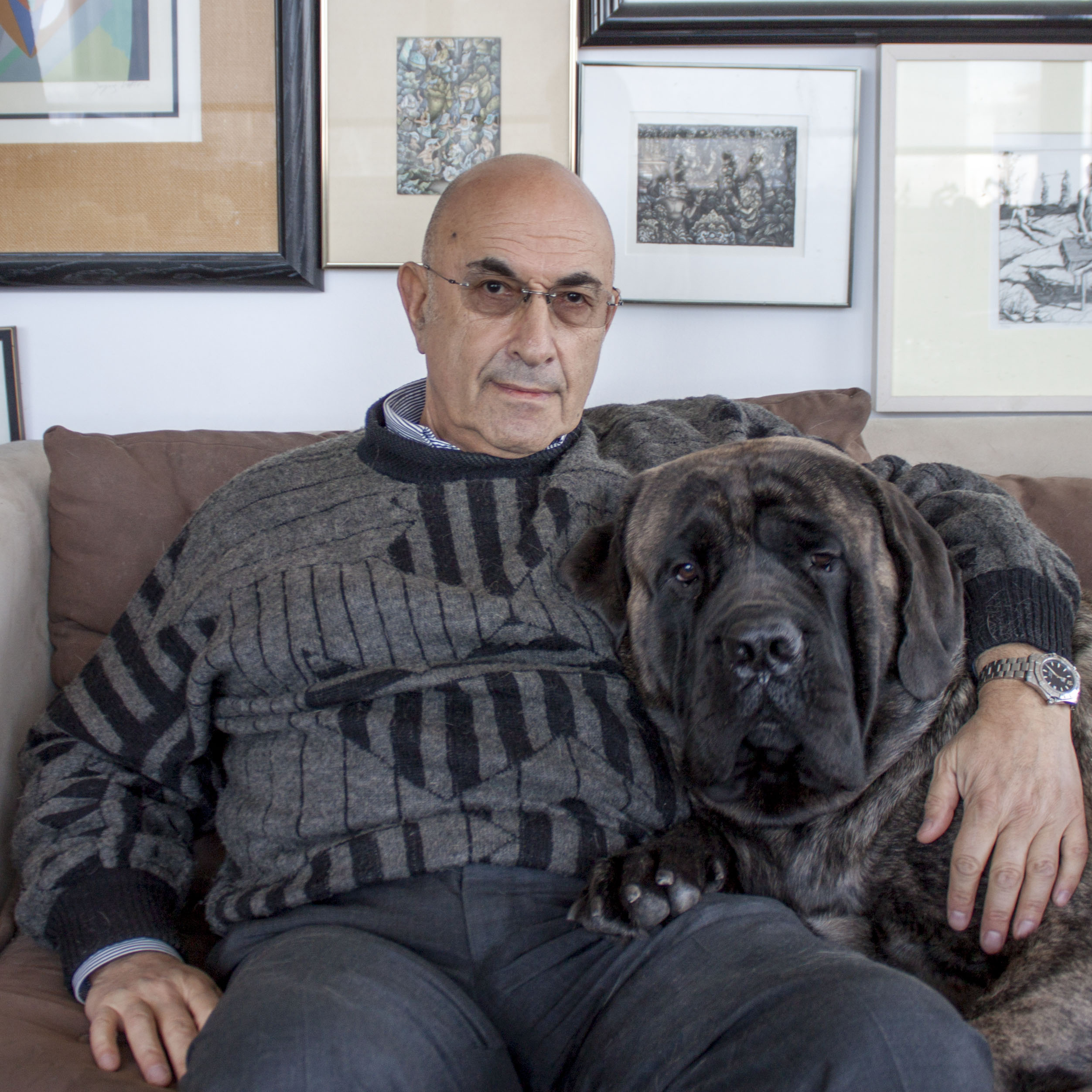 Dr. Elkhonon Goldberg seated at home with his dog